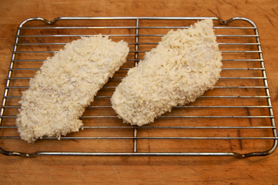 Breadcrumbed curry chicken breasts on a rack.jpg.