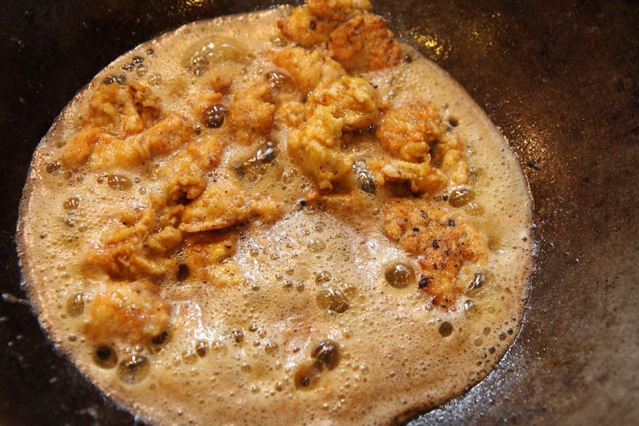 Chicken pieces frying in the wok.jpg.