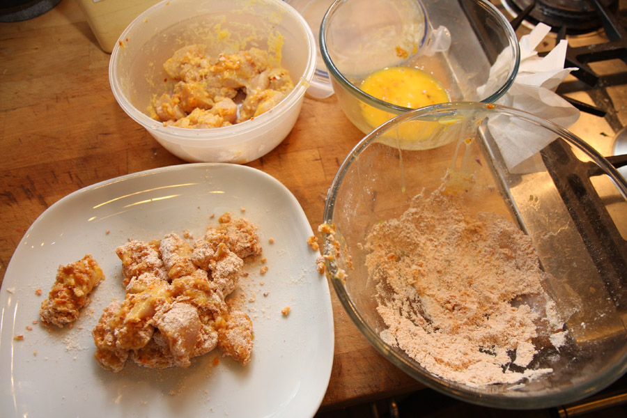 Chicken pieces coated with flour, ready to fry.jpg.