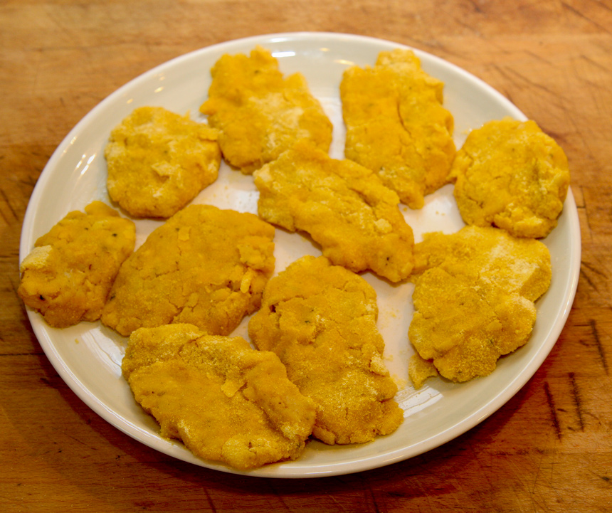 Llapingachos (Potato cakes) rolled in cornmeal.jpg.