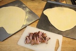 One breast, two pizzas