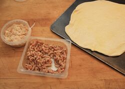 The uncooked base with the crabmeat and brown shrimp