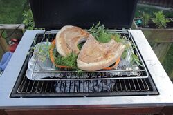 Pork steaks laid on the herbs and raised up higher than normal so they do now burn or overcook