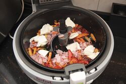 Adding the pasta, ham and mozzarella