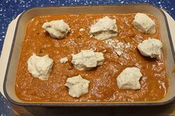 In the stew, dumplings ready to bake