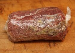 Parma ham, duxelles, mustard and beef fillet, wrapped up in cling film