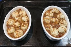 Dumplings, coated with gravy and ready to cook.