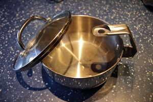 Saucepan handle bent over to fit in a pressure cooker