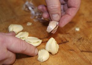 Pull the paper skin away from the garlic clove