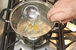 swirl the water with another spoon and then slip the egg into the middle of the pan